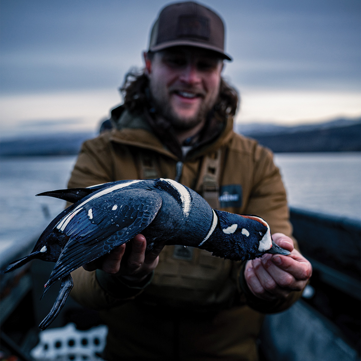 Hunter with harlequin duck. Photo by Weatherby Inc.